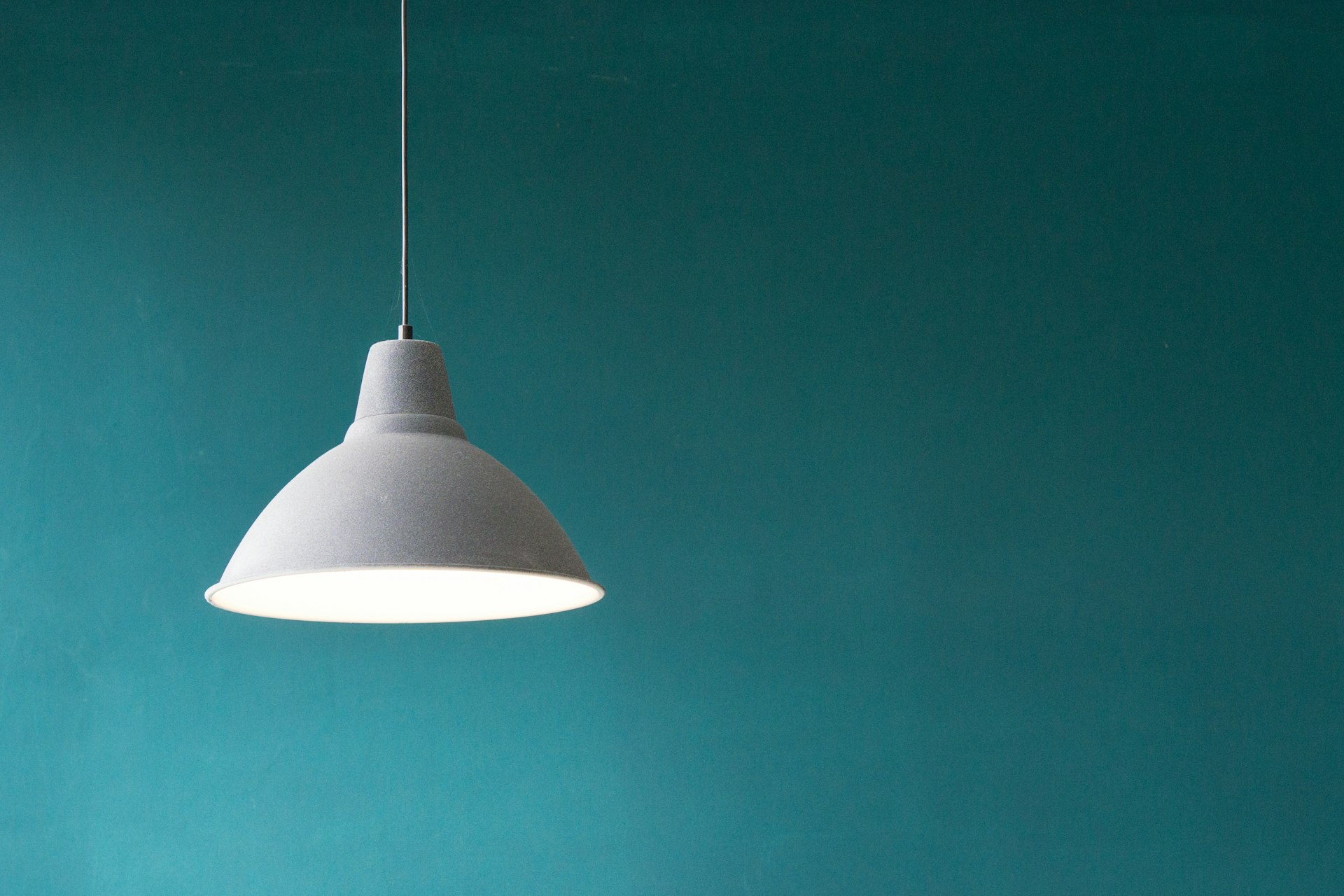 Sculptural brass and travertine home lighting